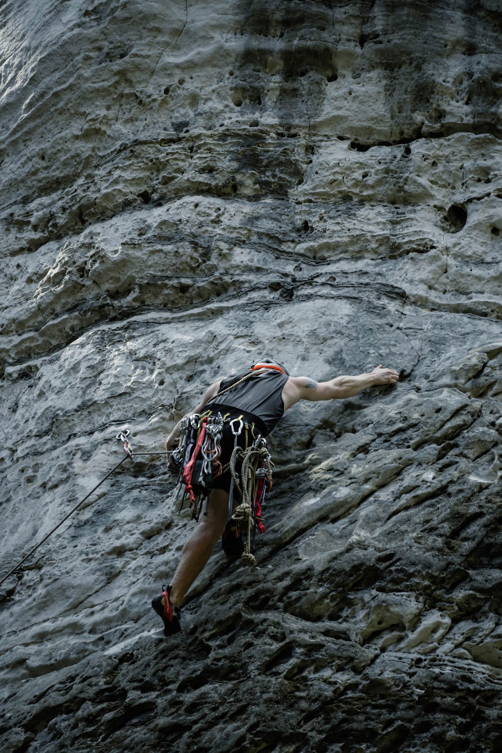 Rock climber on a steep sandstone wall
